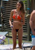 April Love Geary in a bikini barely shows off a baby bump as she hits the pool with Robin Thicke in North Shore, Hawaii
