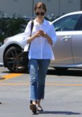 Lily Collins running errands in casual white shirt and jeans in Los Angeles