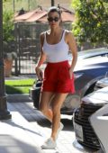 Kourtney Kardashian in a white tank top with red shorts out and about in Los Angeles