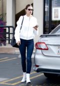 Alessandra Ambrosio wears blue jeans and white knit jacket to match with her white boots as she leaves a spa in Beverly Hill, Los Angeles