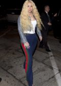 Iggy Azalea rocks Gucci pants with a shiny cropped jacket as she arrives for dinner at Craig's in West Hollywood, Los Angeles