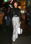 Romee Strijd wearing high waste print trousers and black leather jacket while out in New York City