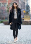 Victoria Justice wears a black fur coat with matching skinny jeans and Chanel purse while out with a friend in New York City