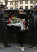 Kendall Jenner arrives at her hotel holding a bouquet of red roses in Paris, France