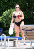 Ashley Graham in a black bikini enjoys a pool day with her friends in Miami, Florida