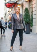 Iskra Lawrence steps out in striped grey blazer and black leather pants during Paris Fashion Week in Paris, France