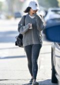 Vanessa Hudgens steps out in a grey sweater, leggings with an Adidas hat as she leaves a Pilates class holding a cup in Los Angeles