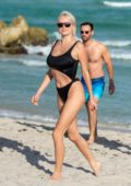 Caroline Vreeland rocks a black bikini as enjoys a beach day with a mystery man in Miami, Florida