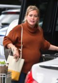 Hilary Duff wears a brown sweater and jeans while picking up groceries at Whole Food in Los Angeles