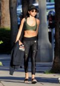 Sarah Hyland shows of her fit body in a green sports bra and black space print leggings as she leaves the gym in Los Angeles