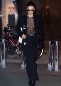 Bella Hadid wears a black blazer over a sheer top as she leaves Victoria's Secret offices in New York City