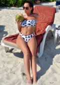Chloe Goodman wears a black and white bikini as she enjoys the sun while sipping her coconut water at the beach in Thailand
