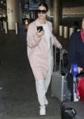 Camila Morrone stopped to exchange some money after she touched down at LAX airport in Los Angeles