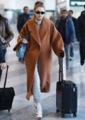 Gigi Hadid wore a brown long coat with grey turtleneck and sweatpants as she arrives at the airport to fly out of Milan, Italy