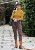 Julianne Hough looks stylish in a mustard yellow turtleneck, checkered pants with brown boots and grey fedora while out with Derek Hough in Los Angeles