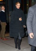 Rosie Huntington-Whiteley bundles up in a black puffer jacket as she heads to the airport in New York City