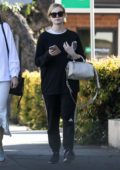 Elle Fanning steps out in black Adidas sweats during a trip to a nail salon with her mother in Los Angeles