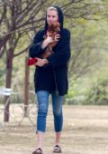 Ireland Baldwin cuddles her Dachshund during an afternoon outing to the dog park in Los Angeles