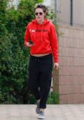 Kristen Stewart keeps it casual in a red hoodie and black sweatpants while visiting a spa in Los Angeles