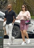 Ashley Graham wears a soft pink wool top and mauve silk mini-skirt while out for a stroll in Tribeca, New York City