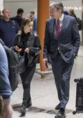 Emilia Clarke sports an all black look as she touches down at Heathrow Airport in London, UK