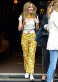 Suki Waterhouse wears bright yellow floral pants with a white top as she leaves The Bowery Hotel in New York City