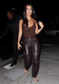 Kourtney Kardashian wears a brown tank top and leather pants as she arrives at the Nice Guy in West Hollywood, Los Angeles