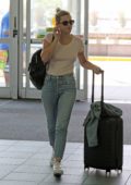 Lili Reinhart wears a simple blush tee and jeans as she arrives at Vancouver airport, Canada