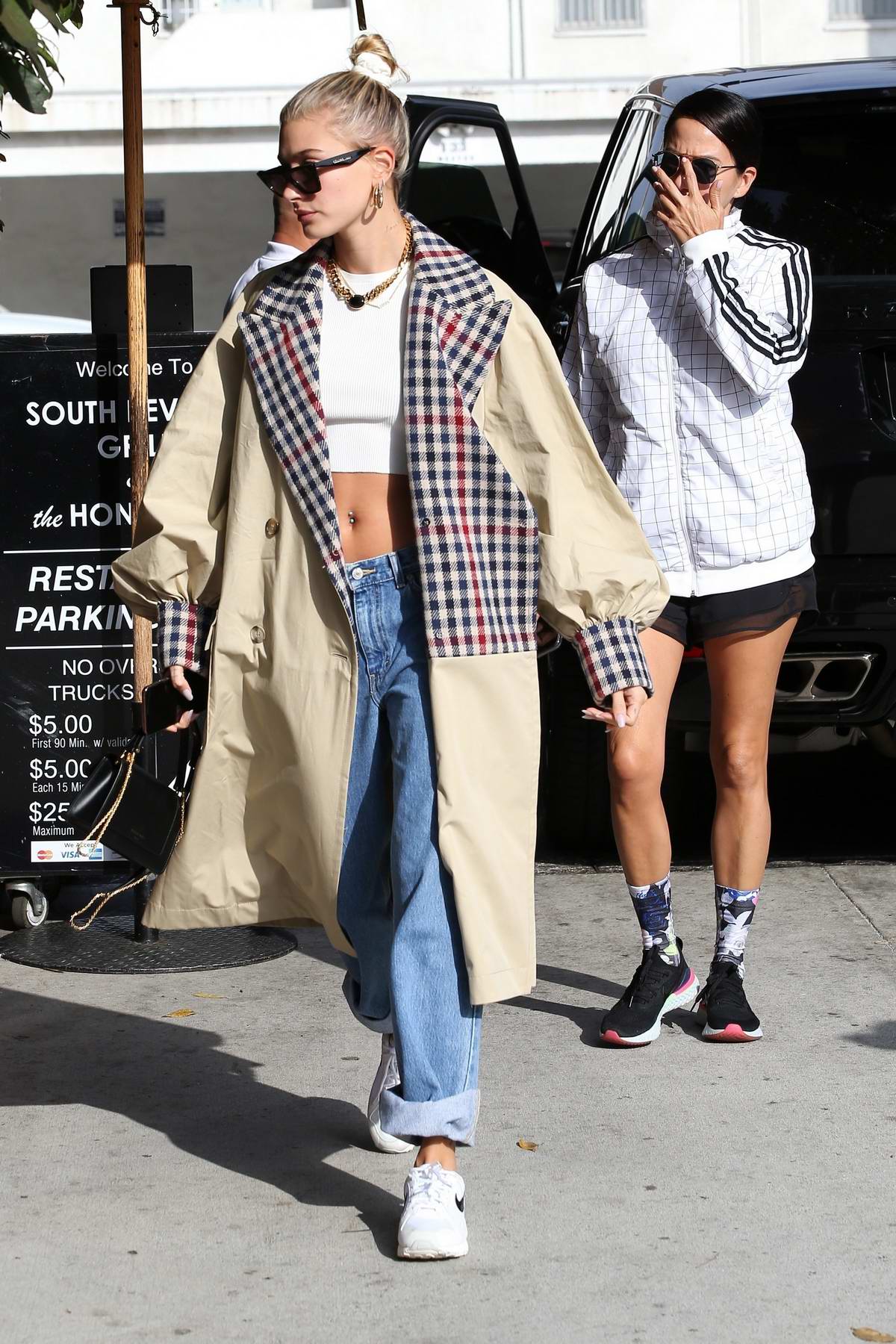 hailey baldwin looks stylish in a crop top and trench coat while ...