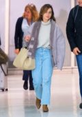 Emilia Clarke is all smiles as she arrives at JFK Airport in New York City