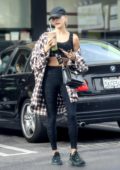 Hailey Bieber shows off her toned physique in a black sports bra and leggings as she stops for a green juice after gym in Los Angeles