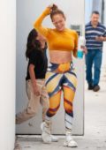 Jennifer Lopez flaunts her toned abs in a mustard yellow crop top as she leaves a dance studio in Miami, Florida