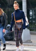 Nina Agdal rocks a cropped blue sweater and plaid trousers as she steps out in the West Village in New York City