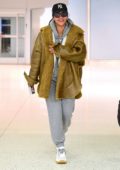 Rihanna seen wearing grey sweatsuit with her Fenty jacket as she arrives for a flight out of JFK airport in New York City