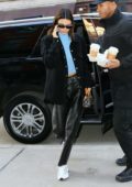 Kendall Jenner wears a black jacket with a blue turtleneck and black leather pants as she steps out for lunch in New York City