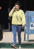 Kesha keep it casual with a sweatshirt and denim tights as she exits a building while on her phone in Los Angeles