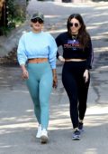 Rita Ora flaunts her abs in a blue crop top and leggings while out on a hike with friends in Los Angeles