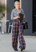Amber Heard looks stylish in a striped shirt and plaid trousers while attending a business meeting in Beverly Hills, California