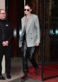 Gigi Hadid wears a grey blazer and black leather pants as she leaves Royal Monceau hotel in Paris, France