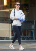 Rosie Huntington-Whiteley puts on a mask and gloves as she stops by Rite Aid in Los Angeles