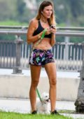 Kelly Bensimon wears a black crop top and colorful shorts as she steps out to walk her dog around Palm Beach, Florida