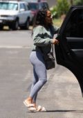 Christina Milian sports a green sweatshirt and grey leggings while out with her kids in Los Angeles