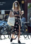 Lily James looks great in a black floral print dress as she picks up some groceries in Primrose Hill, London, UK