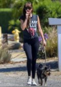 Dakota Johnson looks cute and casual as she walks her dog in Malibu, California