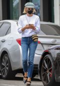 Diane Kruger wears a white sweater and jeans during a shopping trip in Brentwood, California