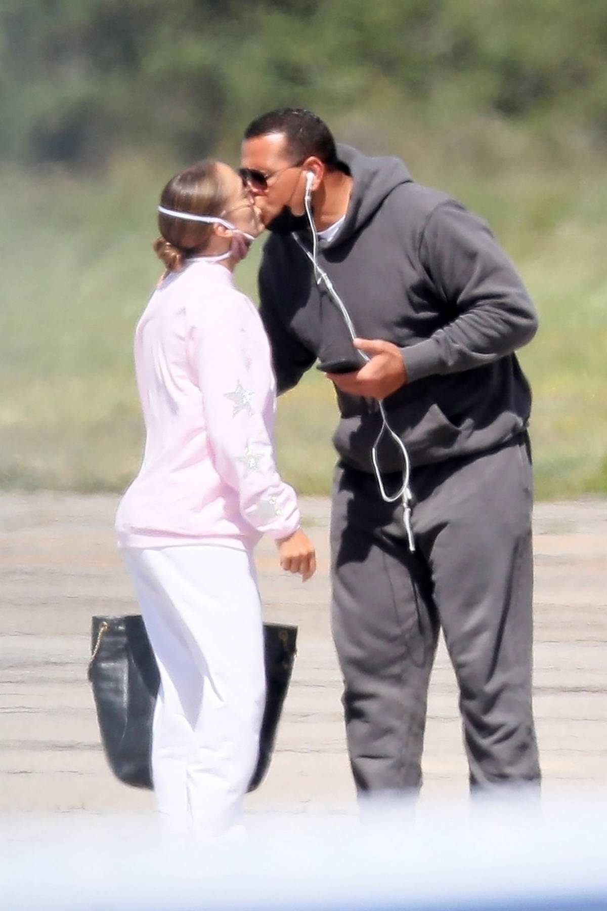 Jennifer Lopez and Alex Rodriguez share a kiss at a private airport