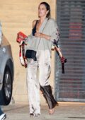 Alessandra Ambrosio looks stylish in beige silk pants during a dinner outing with friends at Nobu in Malibu, California