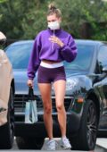 Hailey Bieber flaunts her toned legs in purple Nike shorts with matching crop top while visiting a friend in Los Angeles