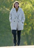 Emma Corrin looks cozy in a warm coat as she takes a morning walk with her dog and a friend in North London, UK