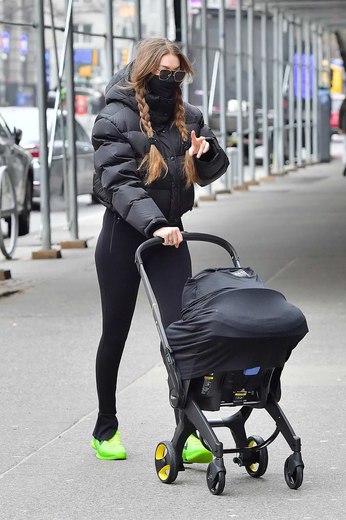 gigi hadid sports a black puffer jacket and leggings while out with her  baby daughter in soho, new york city-110121_7